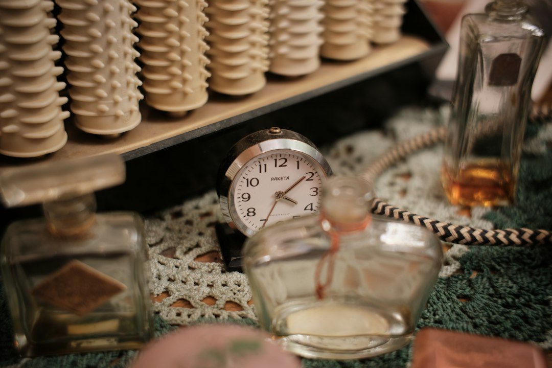 Vintage hair rollers, perfume bottles, and alarm clock