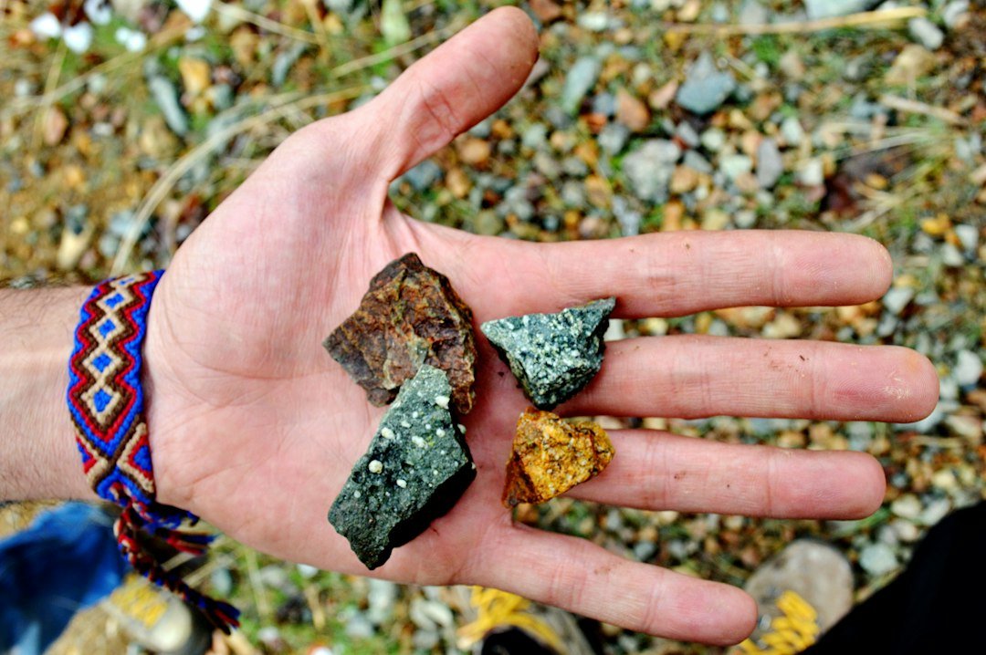a person holding two rocks in their hand