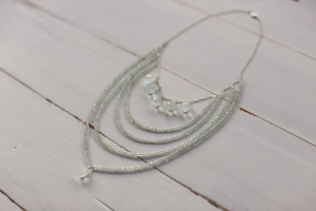 a close up of a necklace on a wooden surface